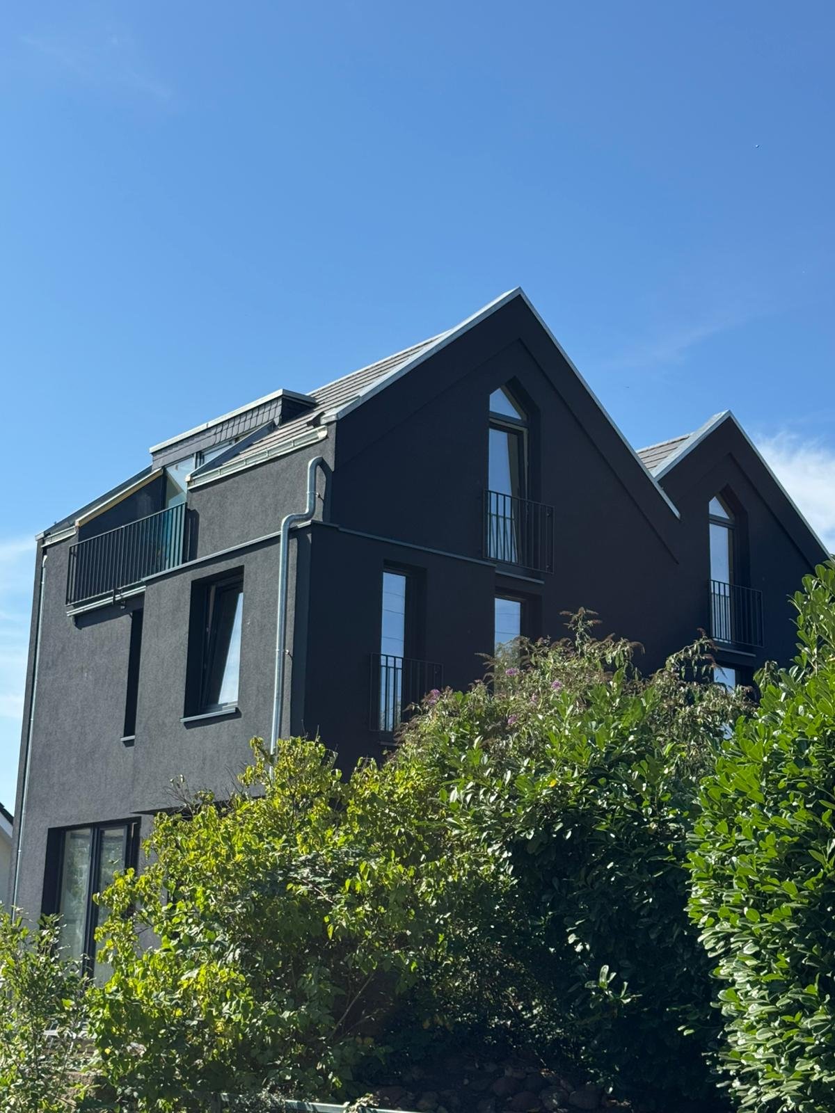 Seitliche Ansicht des Berliner Wohngebäudes mit Dachform und Balkon